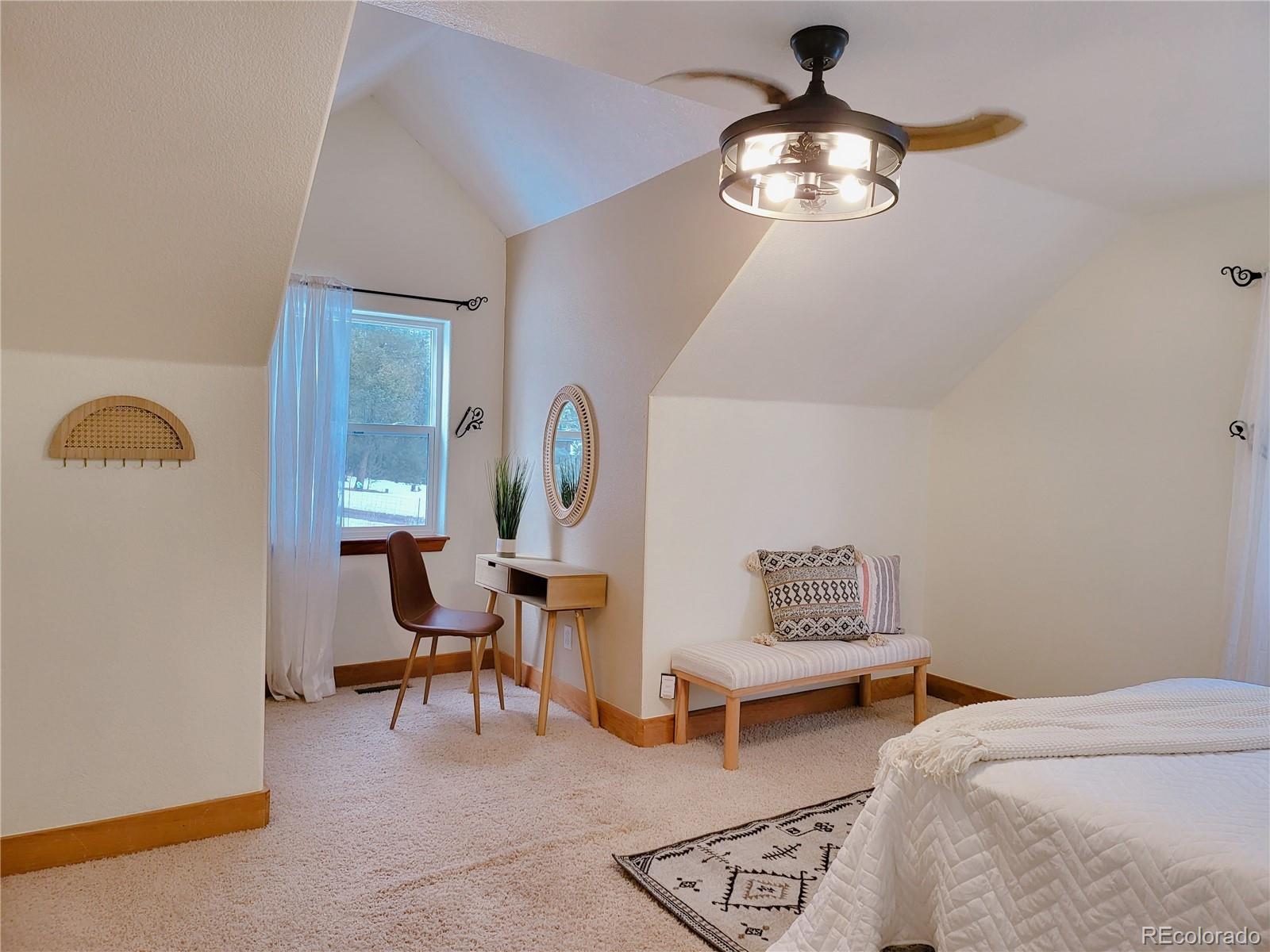 20133 Silver Ranch Road Conifer, CO 80433 - Photo 19 of 40 a bedroom with bed and a window