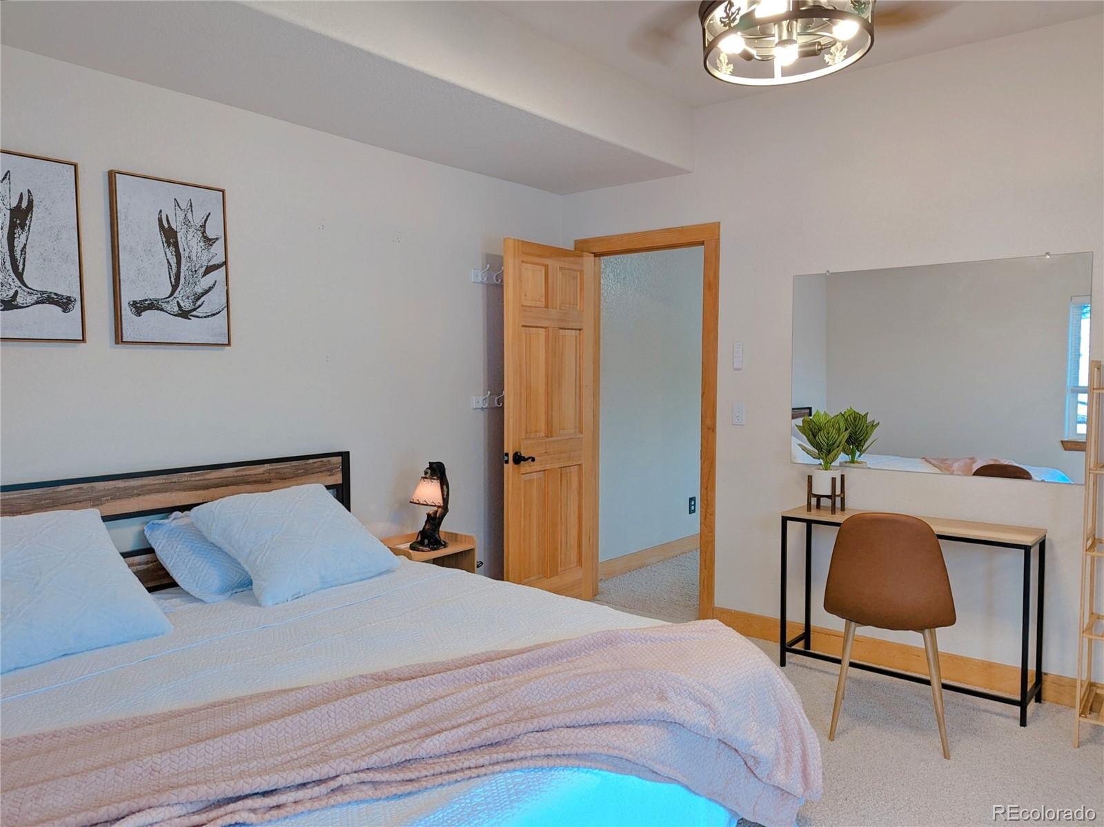 20133 Silver Ranch Road Conifer, CO 80433 - Photo 28 of 40 a bedroom with a bed and a chair