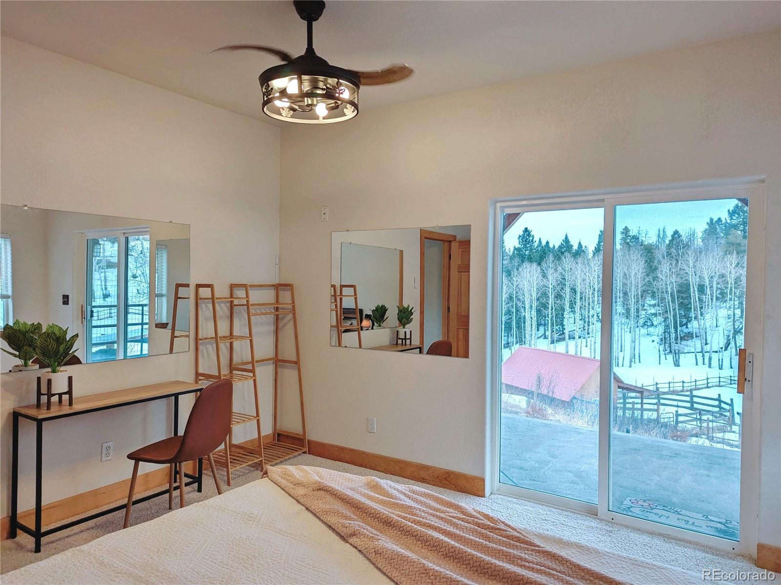 20133 Silver Ranch Road Conifer, CO 80433 - Photo 29 of 40 a dining room with wooden floor and windows