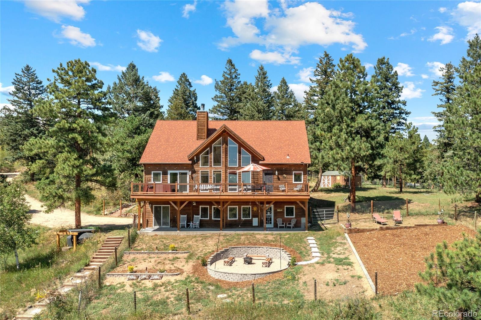 20133 Silver Ranch Road Conifer, CO 80433 - Photo 34 of 40 an aerial view of a house with swimming pool and large trees