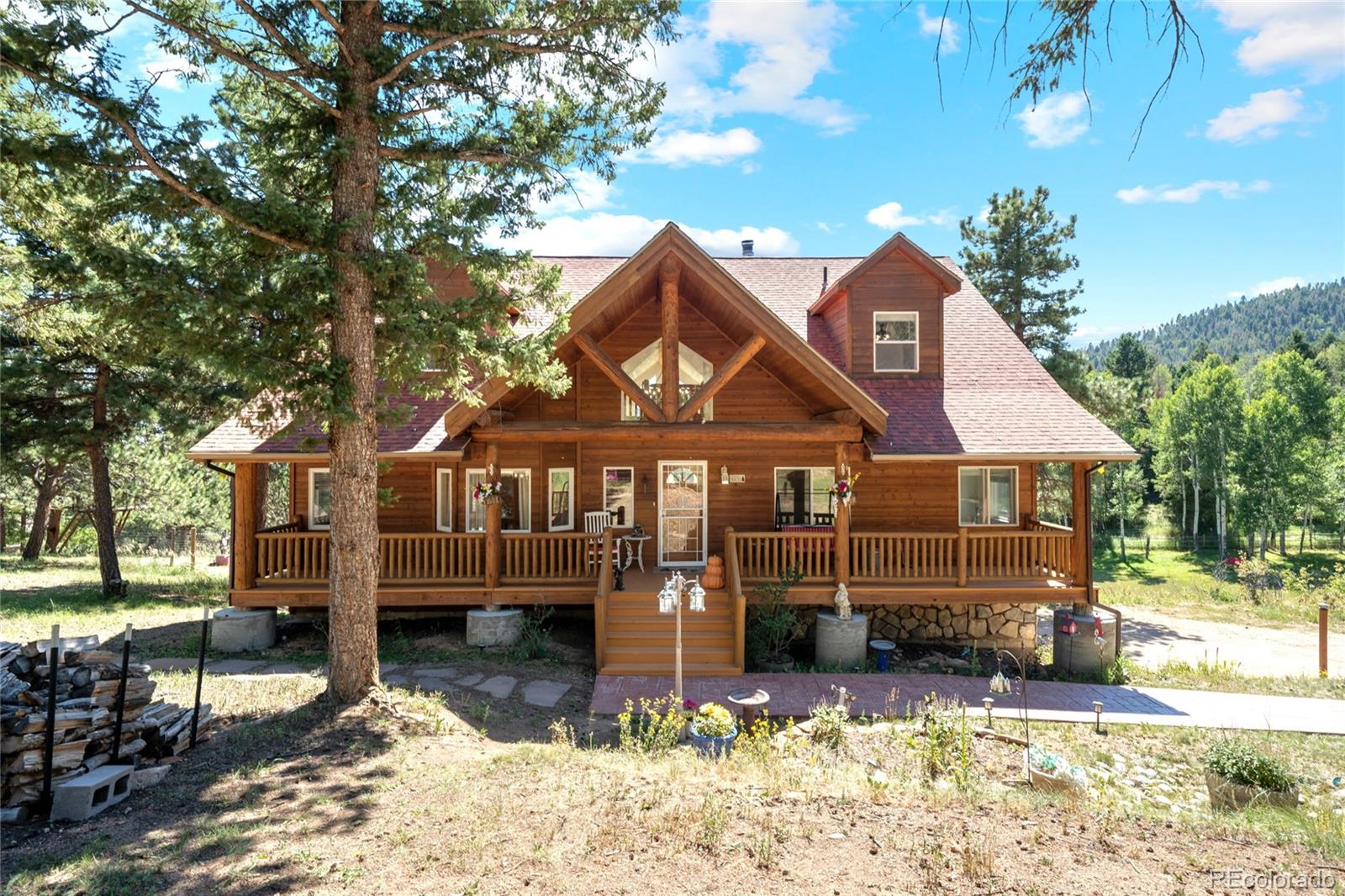 20133 Silver Ranch Road Conifer, CO 80433 - Photo 39 of 40 a front view of a house with a yard