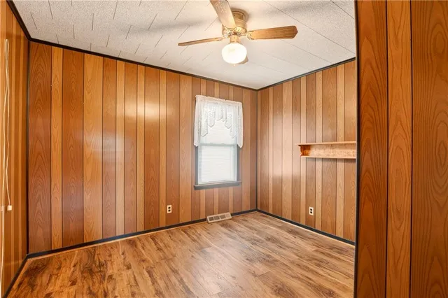 a view of a hallway with stainless steel appliances and furniture