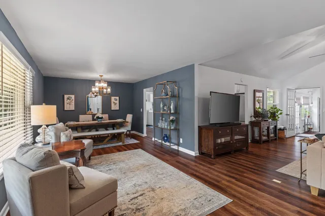 a living room with fireplace furniture and a wooden floor