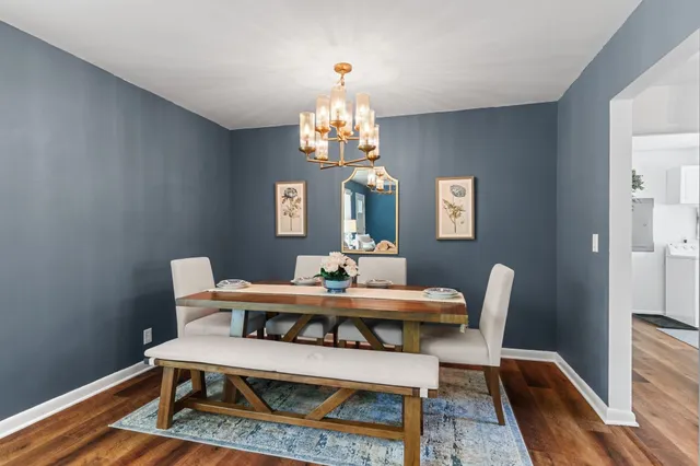 a bedroom with a bed and a flat tv screen on dresser