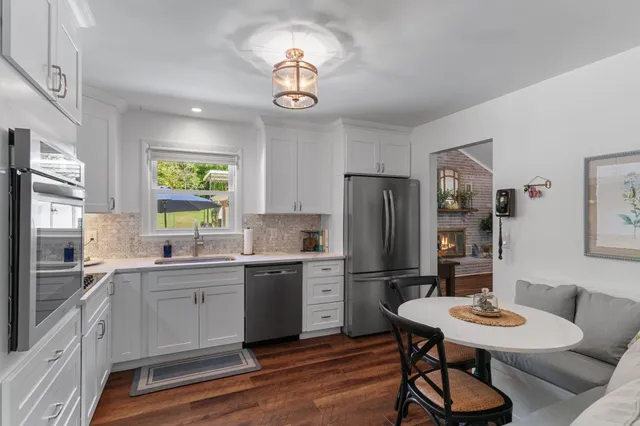 a bathroom with a granite countertop toilet a sink and a mirror
