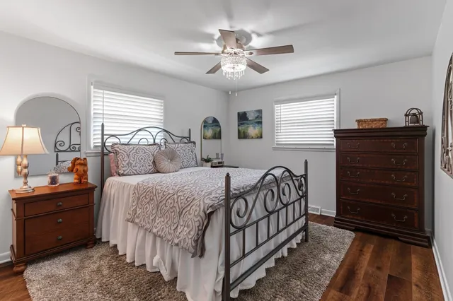 an aerial view of residential house with outdoor space and trees all around