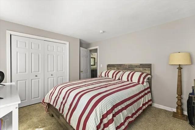 a bedroom with a bed and a lamp