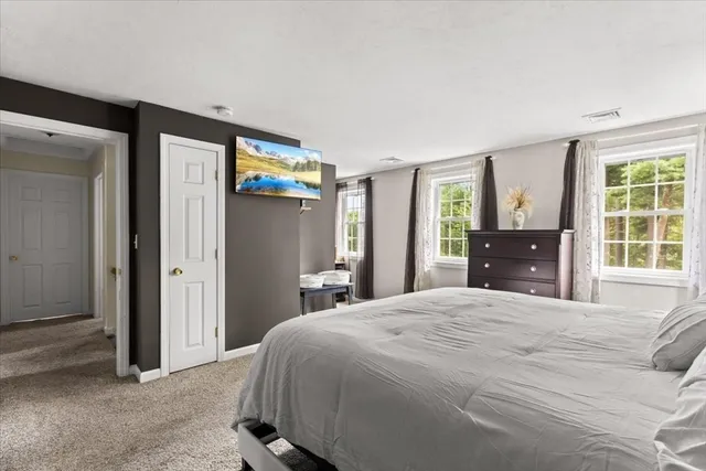 a bedroom with a large bed and a large window