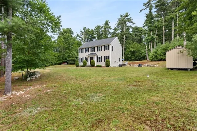 a view of a house with a yard and sitting area