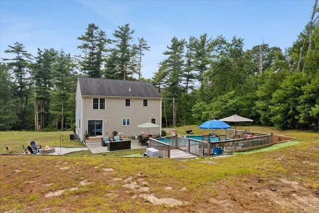 a backyard of a house with table and chairs