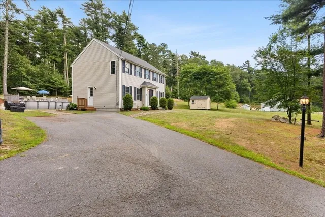 a view of a house with entertaining space and a yard