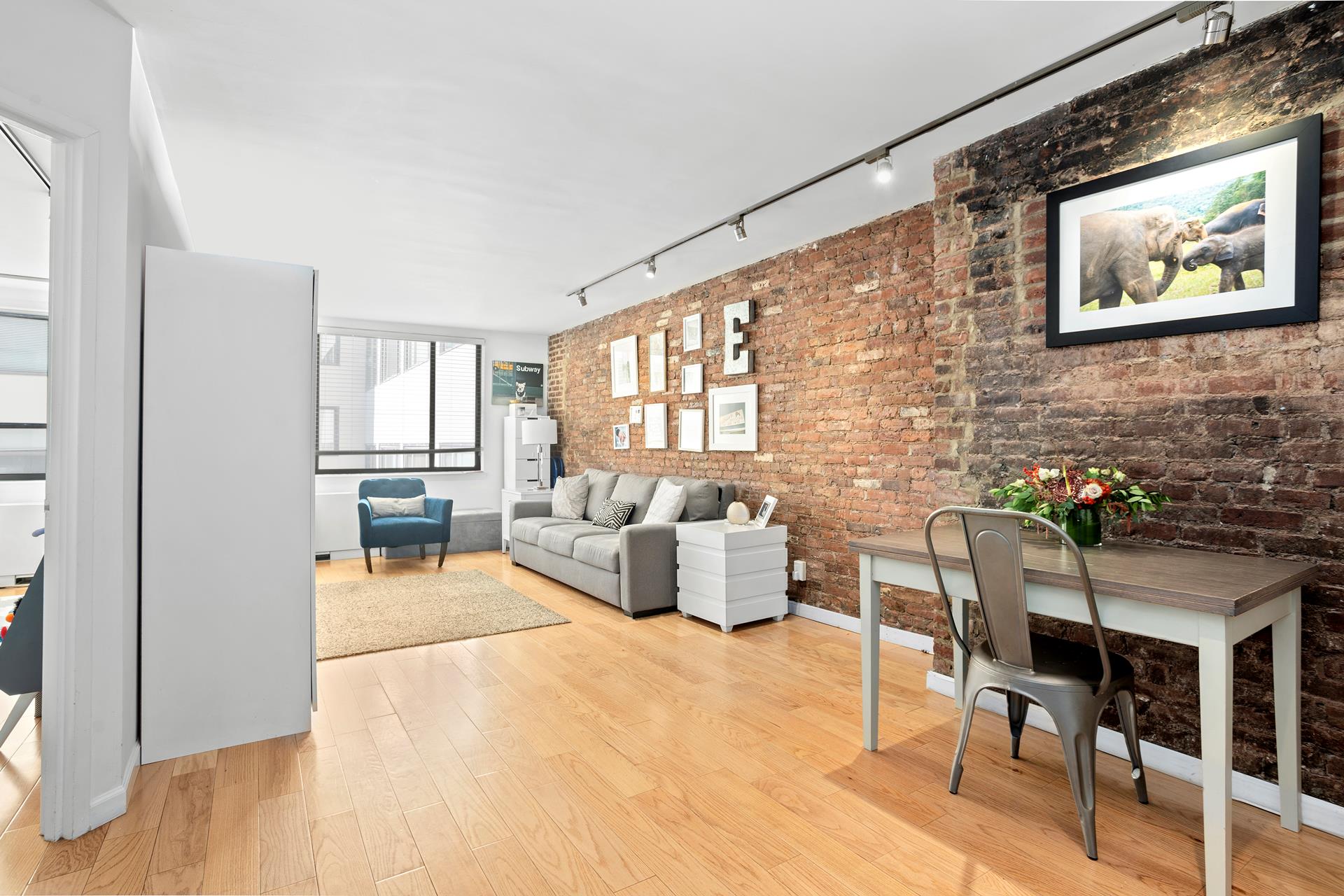 a living room with furniture a rug and a painting on the wall