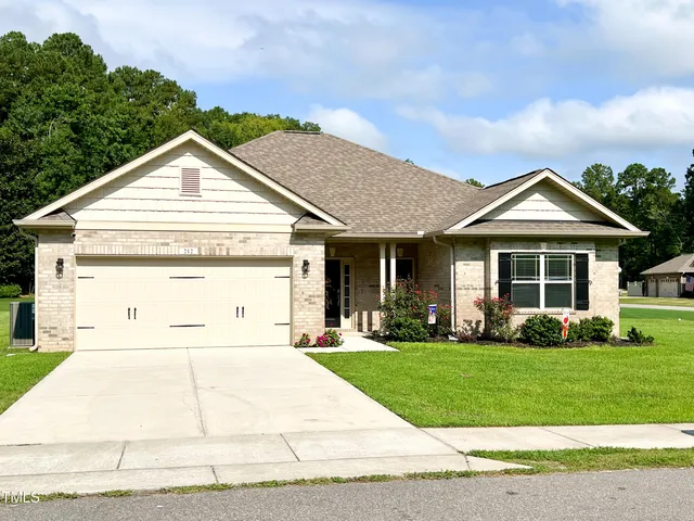 a view of a house with garden and yard