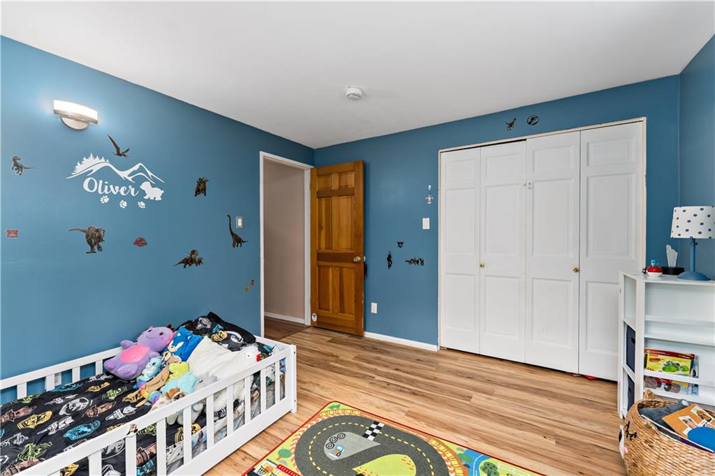 3905 Middleboro Road Pittsburgh, PA 15234 - Photo 18 of 32 a bedroom with a bed and wooden floor