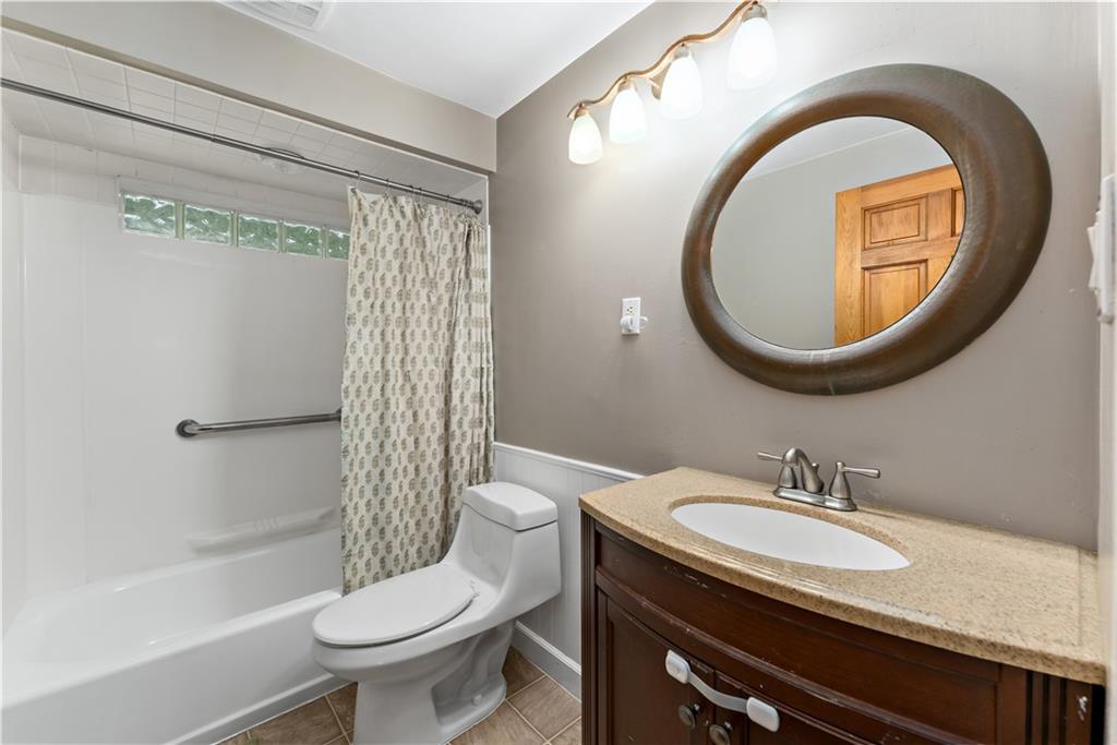3905 Middleboro Road Pittsburgh, PA 15234 - Photo 19 of 32 a bathroom with a sink a toilet and a mirror