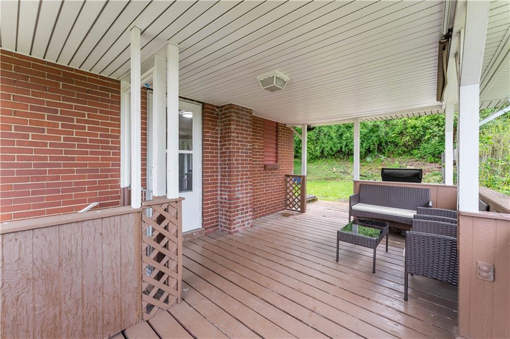 3905 Middleboro Road Pittsburgh, PA 15234 - Photo 24 of 32 a view of a patio with table and chairs with wooden floor and fence