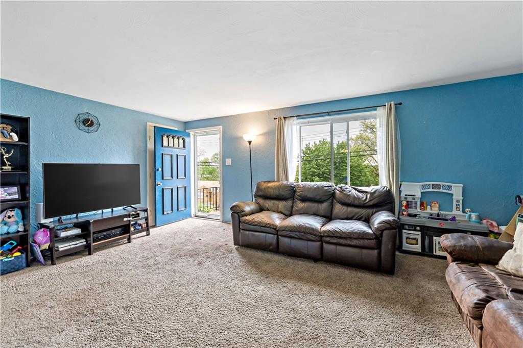 3905 Middleboro Road Pittsburgh, PA 15234 - Photo 6 of 32 a living room with furniture and a flat screen tv