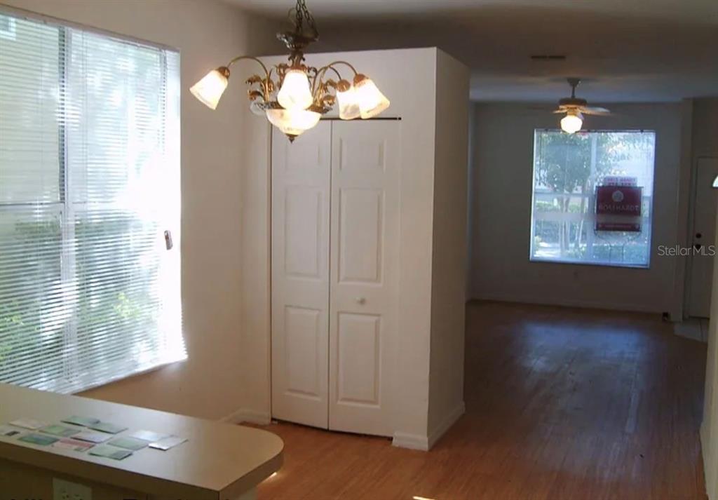 4415 Southwest 34th Street, Unit 708 Gainesville, FL 32608 - Photo 4 of 9 an empty room with windows and chandelier