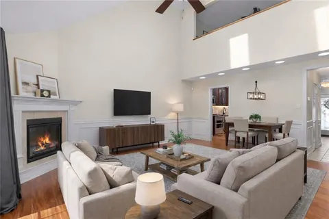 a living room with furniture a fireplace and a flat screen tv