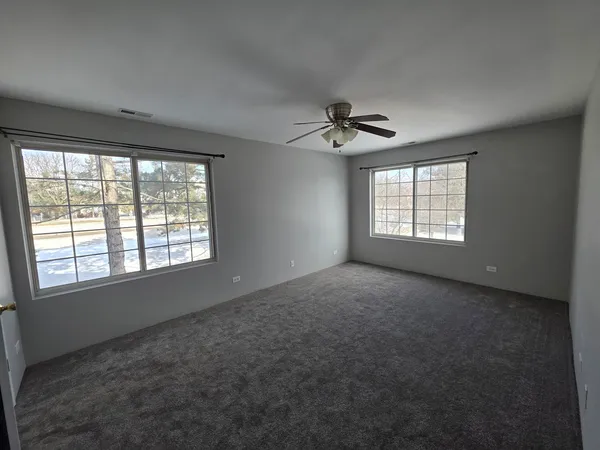 a view of an empty room with windows