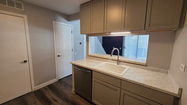 a kitchen with a sink and cabinets