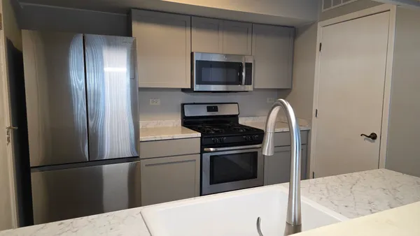 a kitchen with a refrigerator stove and microwave