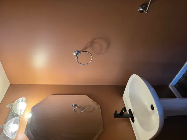 a bathroom with a sink and mirror with toilet