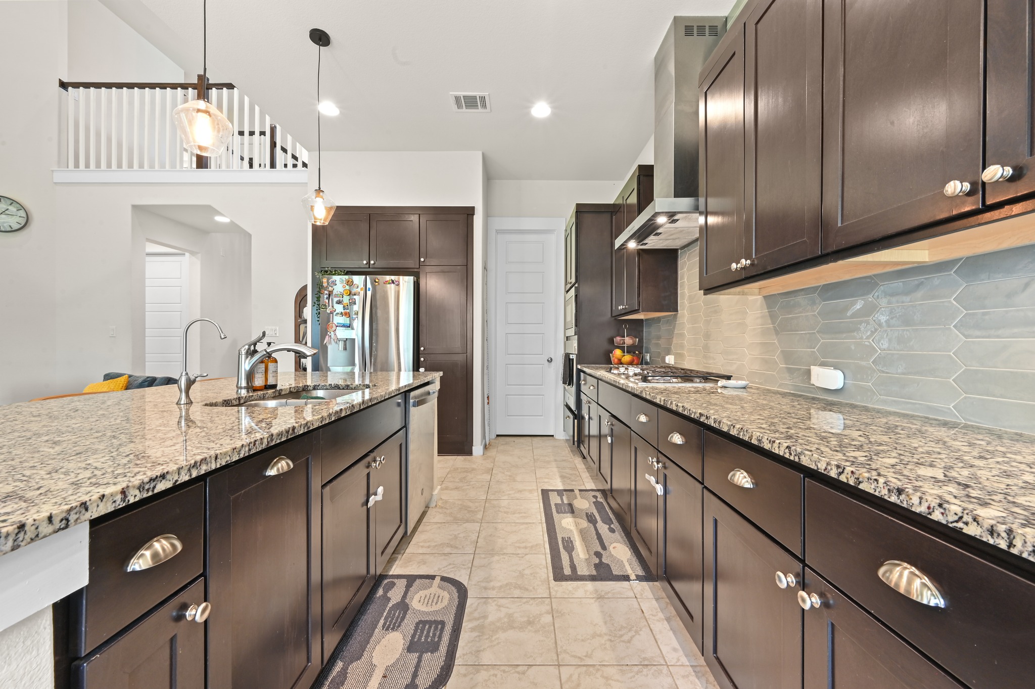 4434 Hannover Way Round Rock, TX 78681 - Photo 12 of 40 a large kitchen with a sink and stainless steel appliances
