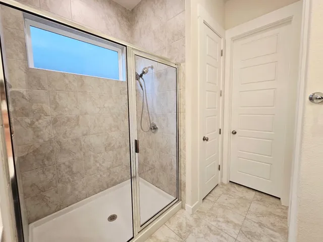 a bathroom with a glass shower door