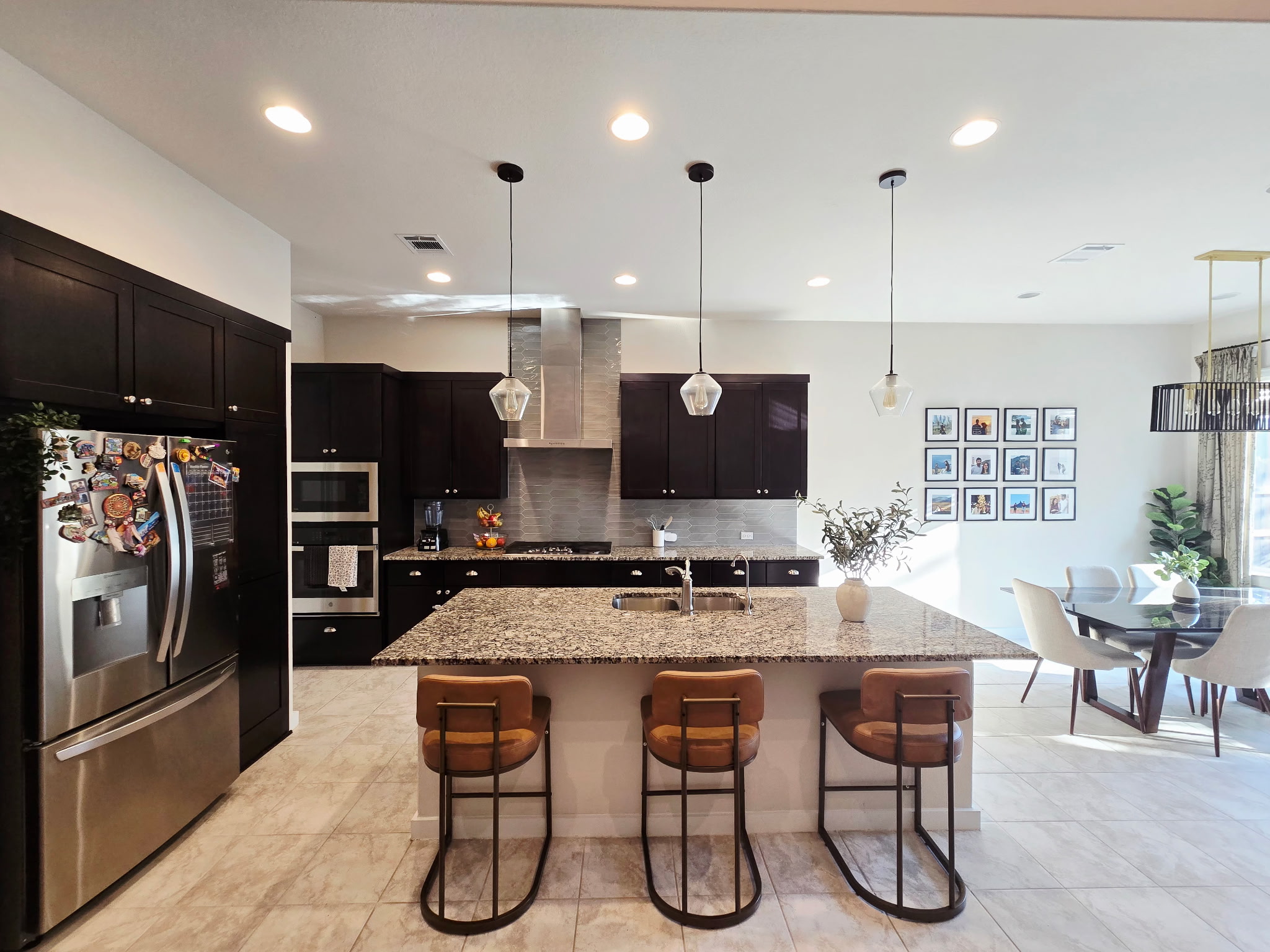 4434 Hannover Way Round Rock, TX 78681 - Photo 3 of 23 Kitchen featuring a breakfast bar, stainless steel appliances, pendant lighting, light stone counters, and a center island with sink