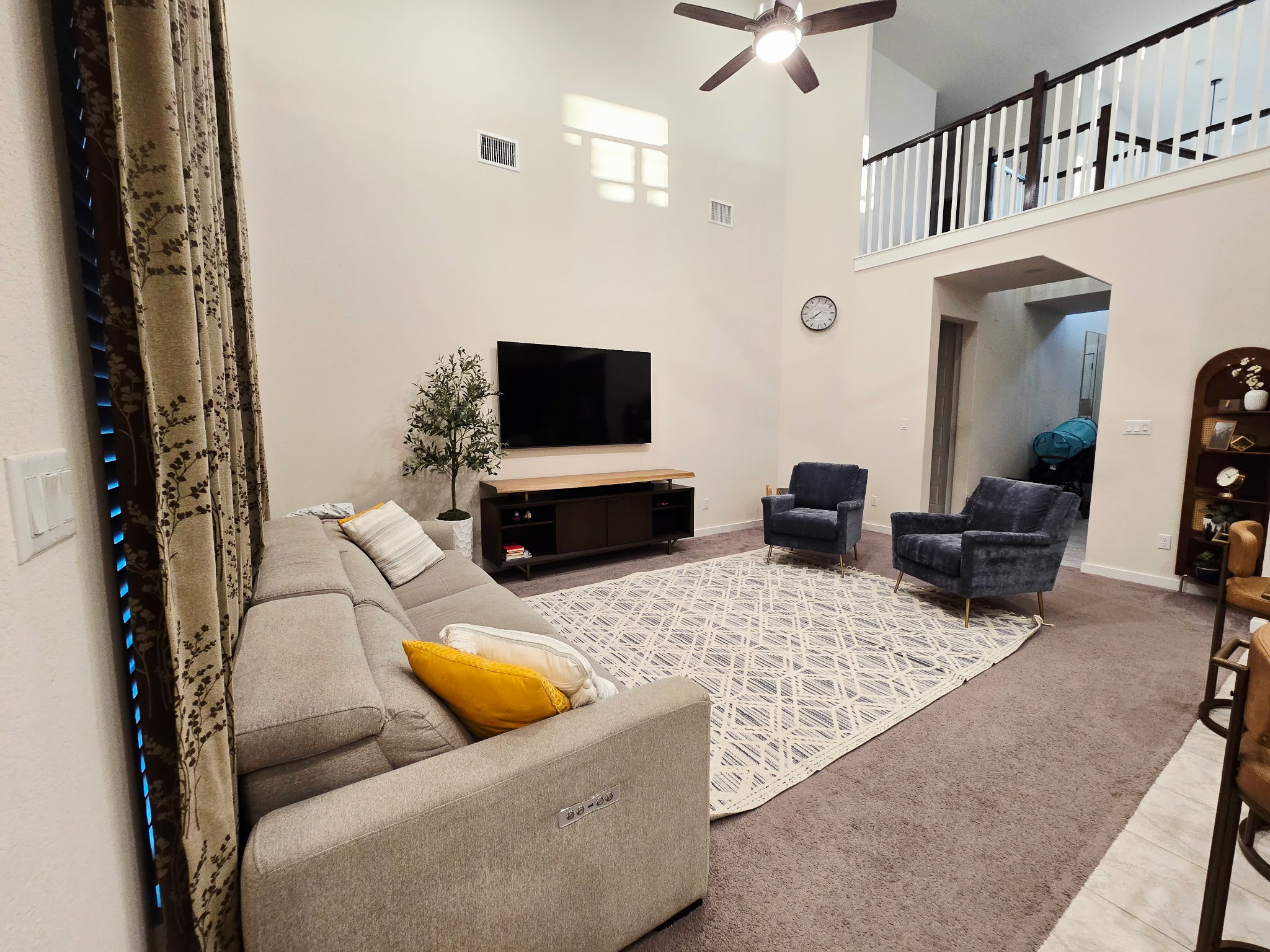 4434 Hannover Way Round Rock, TX 78681 - Photo 7 of 23 Carpeted living room featuring a towering ceiling and a ceiling fan