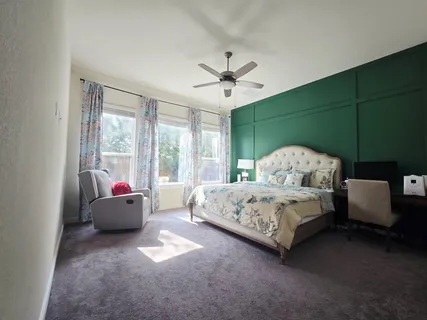 a spacious bedroom with a bed and a couch