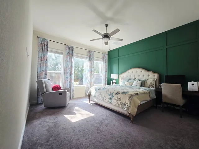 a spacious bedroom with a bed and a couch