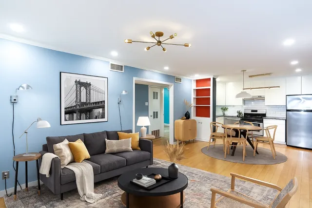 a living room with furniture and kitchen view