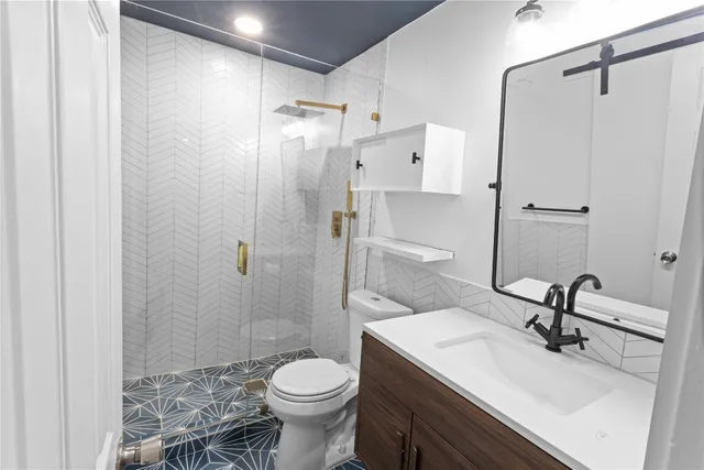 a bathroom with a sink toilet and shower