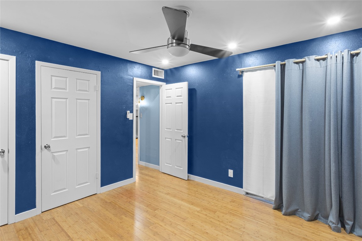 1304 Summit Street, Unit 209 Austin, TX 78741 - Photo 11 of 27 a view of an empty room with a ceiling fan