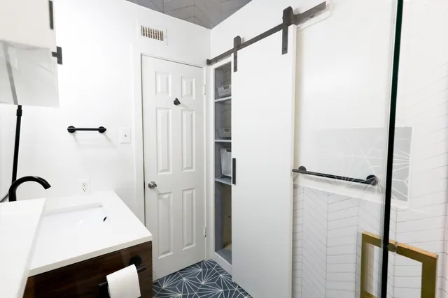 a bathroom with a sink a toilet and shower