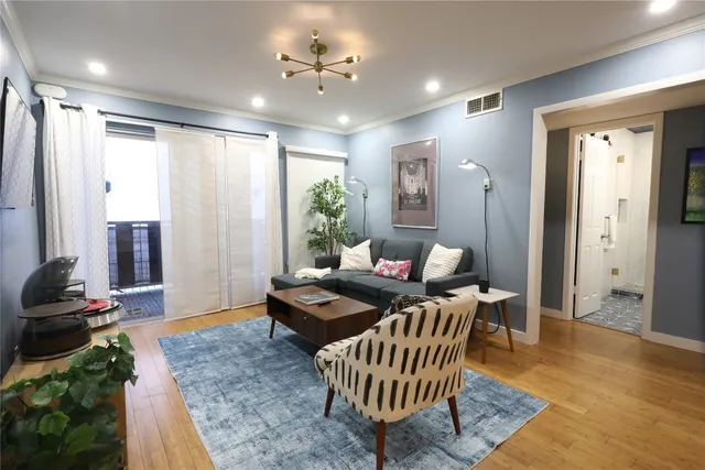 a living room with furniture and wooden floor