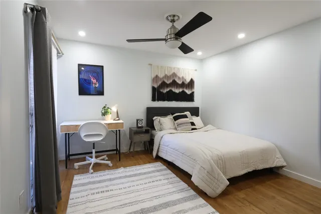 a bedroom with a bed and a painting on the wall