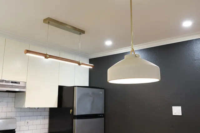 a kitchen with stainless steel appliances granite countertop a stove a sink and a refrigerator