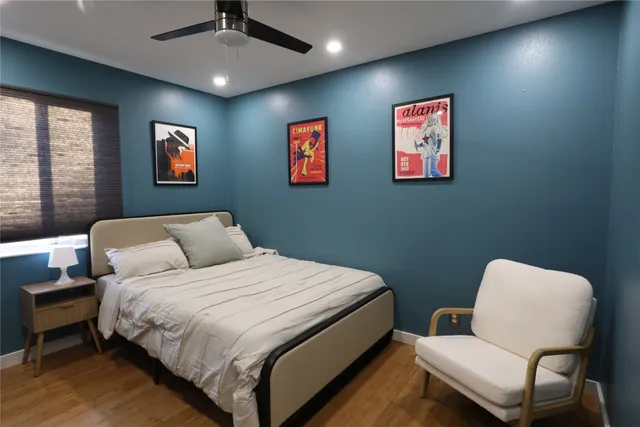 a bedroom with a bed and a chair