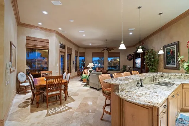 a living room with patio furniture and a floor to ceiling window
