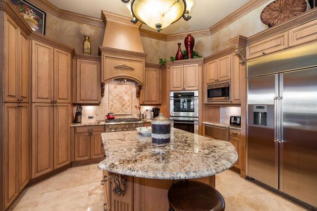 a view of a chairs and table in patio with a swimming pool