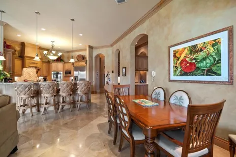 a dining area with furniture and a large window