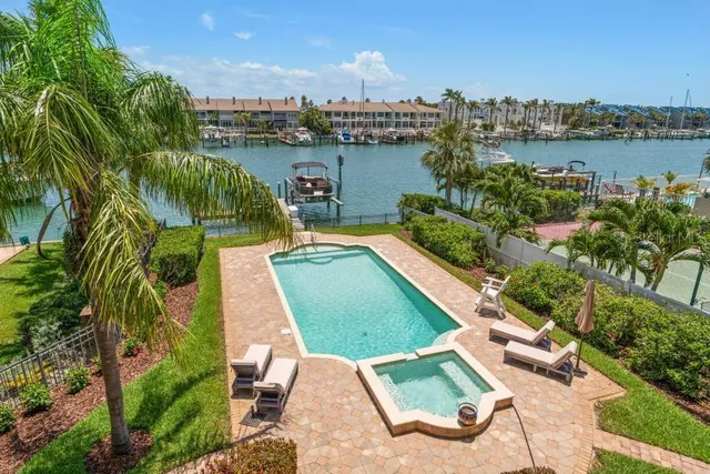 a bedroom with a large bed and windows