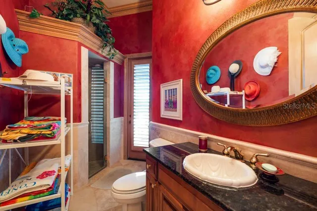 a bathroom with a tub a sink and a large mirror