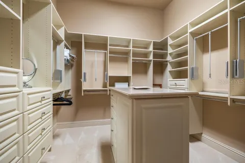 a bedroom with bed and a chandelier