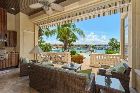 a living room with patio furniture and a floor to ceiling window
