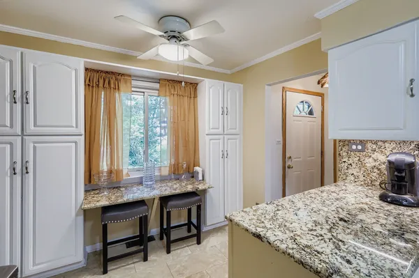 a dining table chair next to a window