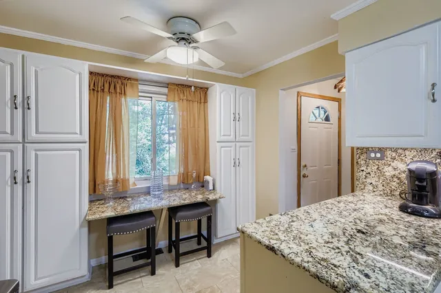 a dining table chair next to a window